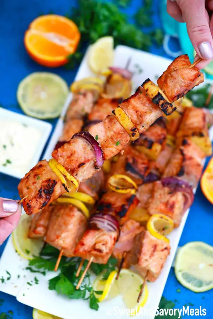 Grilled salmon skewers with pineapple and red onion.