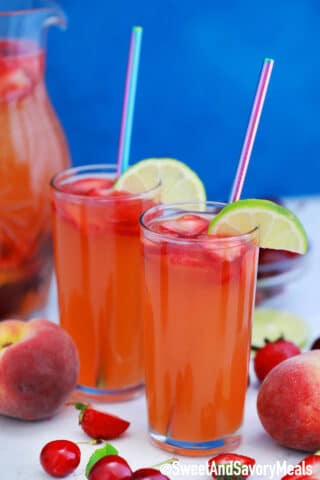 Picture of peach sangria with cherries and strawberries.