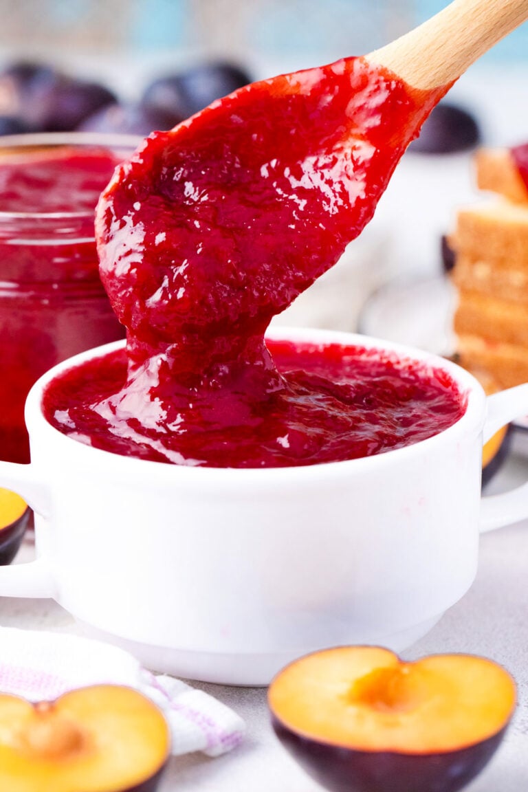 Plum jam dripping of a spoon.