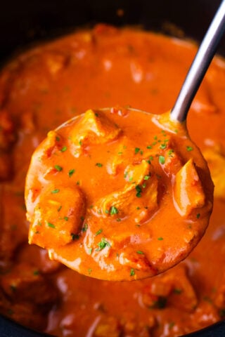 A ladle of creamy slow cooker tikka masala.