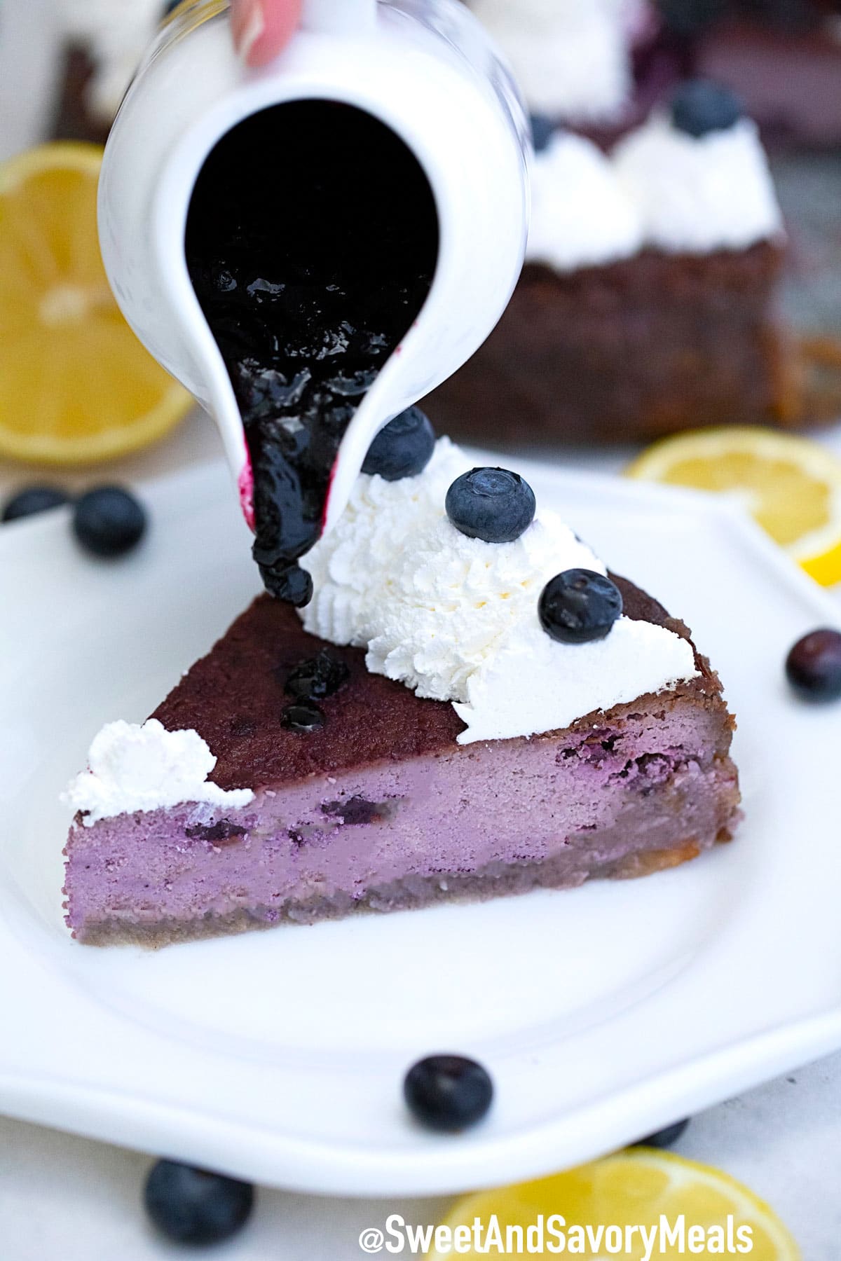 Photo of low carb blueberry cheesecake slice with blueberry sauce.