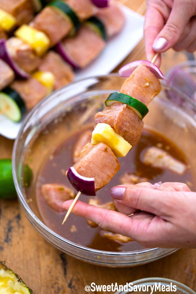 Pork meat and veggies on a skewer.