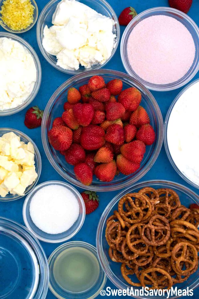 overhead shot of fresh strawberries pretzels cream cheese butter jello in bowls on a table