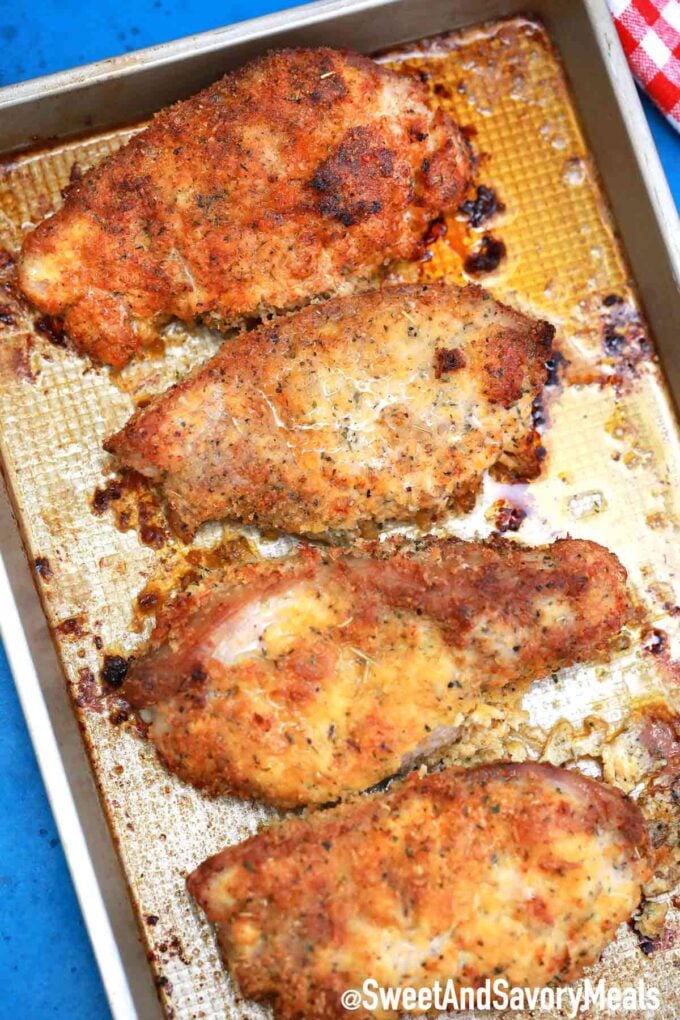 Crispy baked pork chops on a sheet pan.