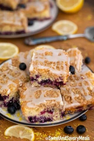 Blueberry buckle bars with fresh blueberries on a plate.