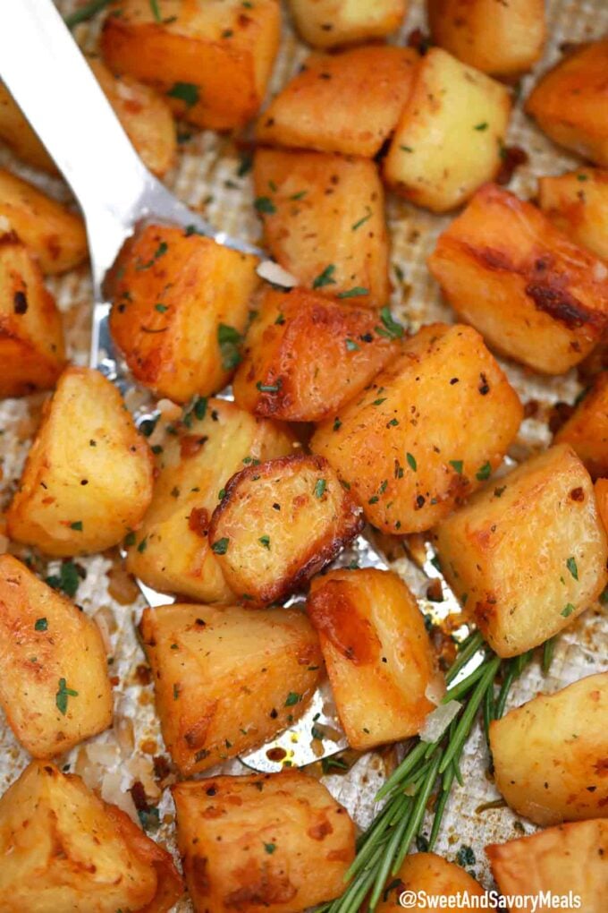 crispy potatoes with rosemary on a baking sheet