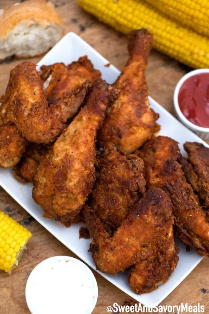 Fried chicken with corn and sauces.