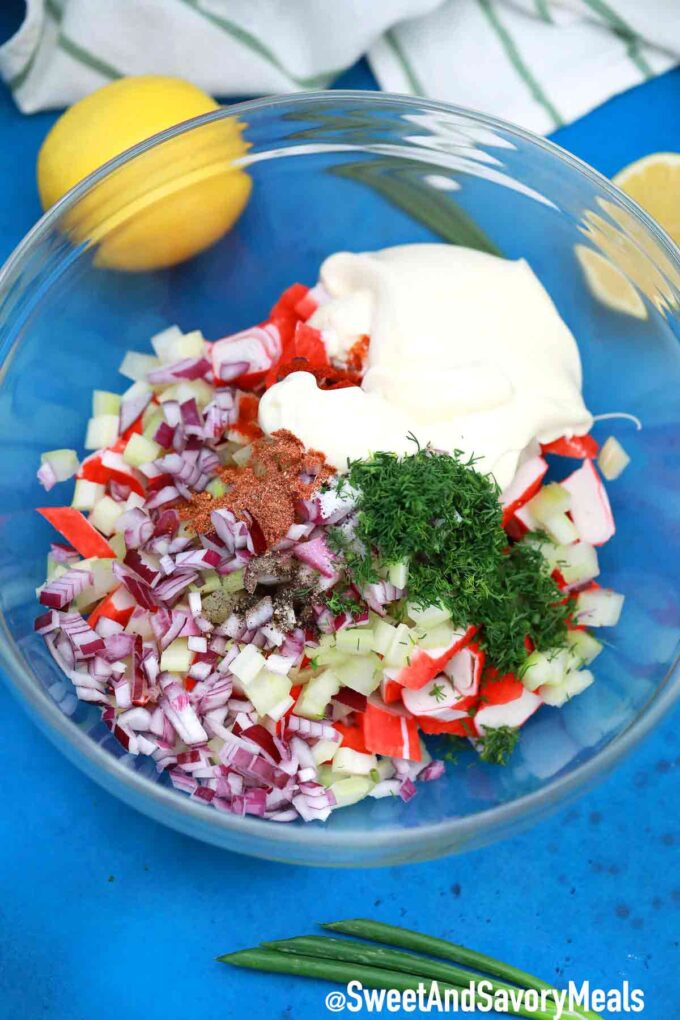 Crab salad chopped ingredients with creamy dressing in a large bowl