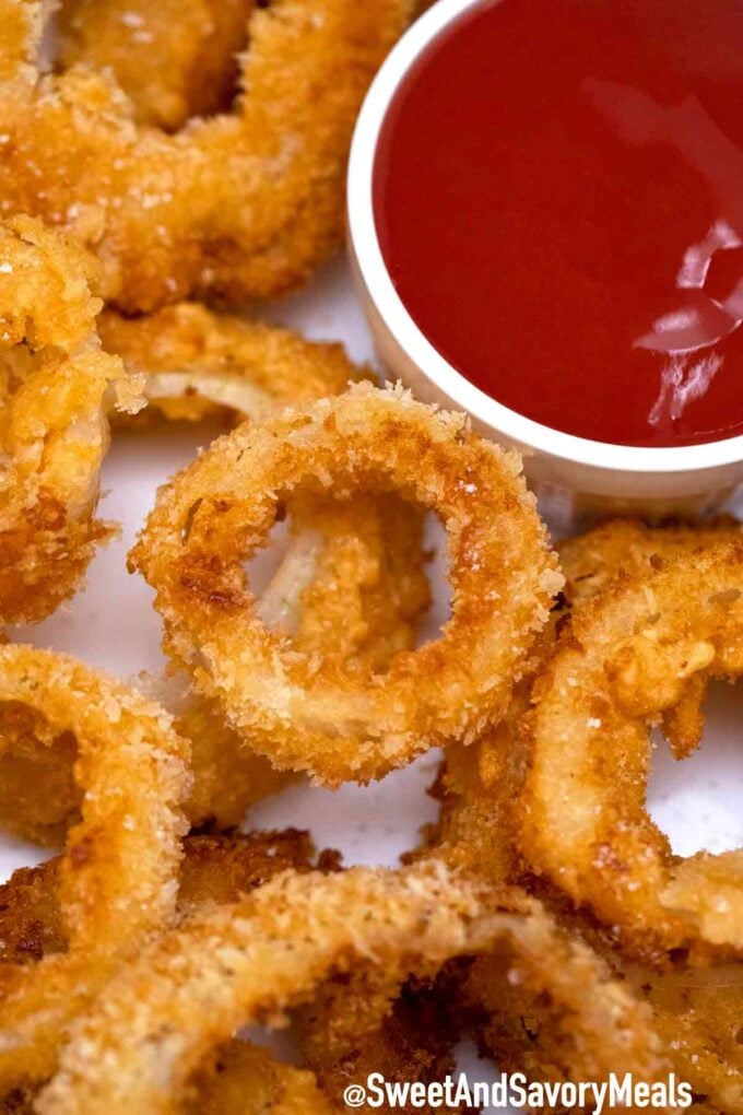 homemade crispy onion rings with ketchup on a plate
