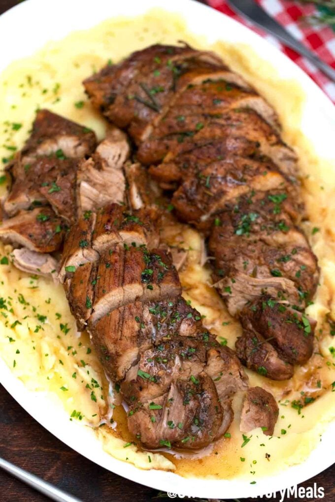 tender sliced pork tenderloin over mashed potatoes