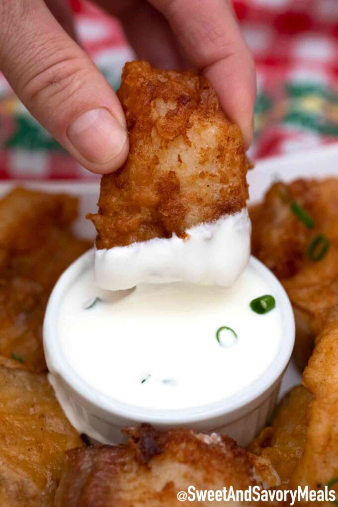 beer battered fish dipped in tartar sauce