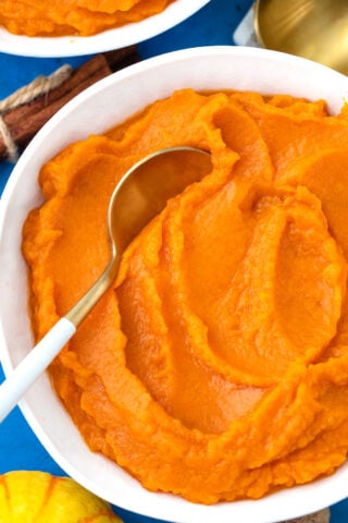 Overhead shot of a bowl of smooth, homemade pumpkin puree.