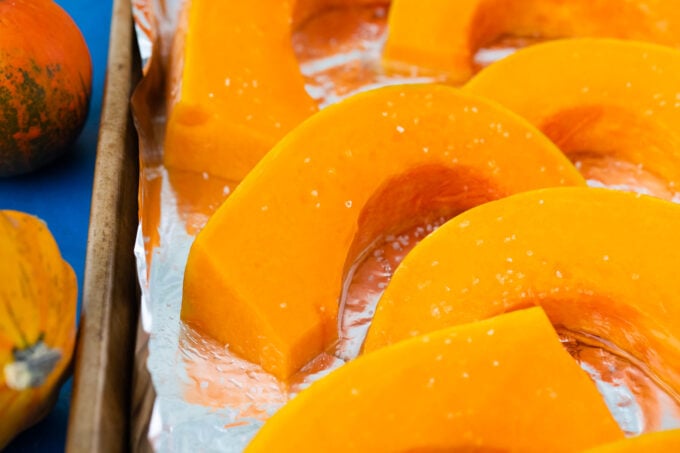 Pumpkin slices on a baking sheet.