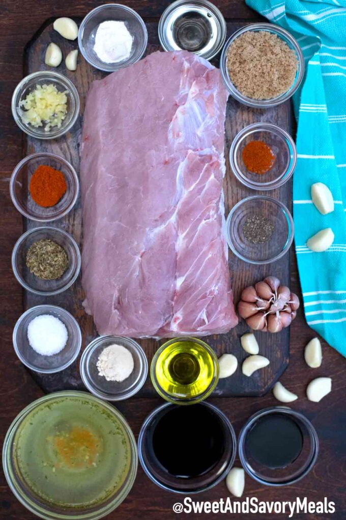 overhead shot instant pot balsamic pork loin ingredients in bowls on a table and a piece of pork loin on a cutting board