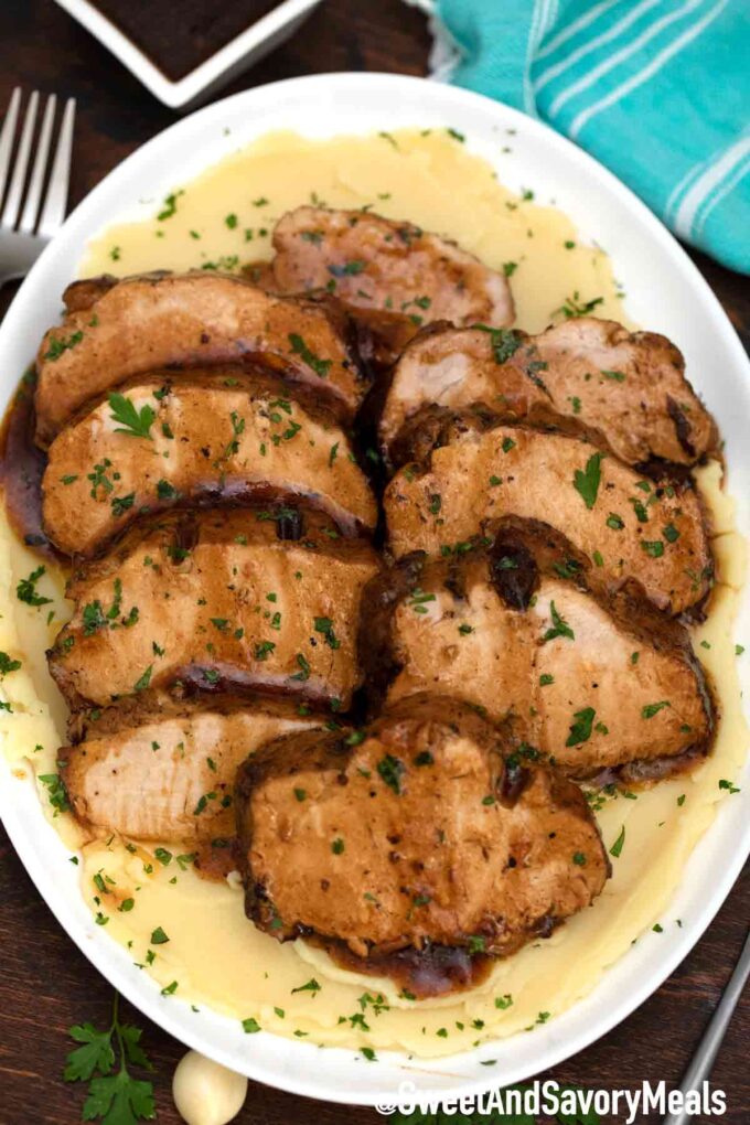 sliced instant pot balsamic pork loin over mashed potatoes