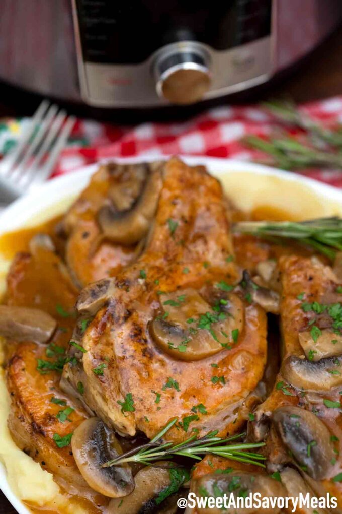 Instant pot pork chops with mushroom sauce garnished with rosemary