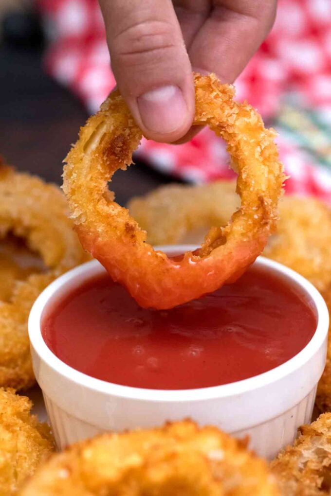 onion ring dipped in ketchup