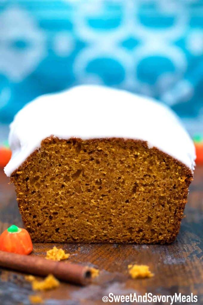 Moist pumpkin bread with glaze on a wooden table 