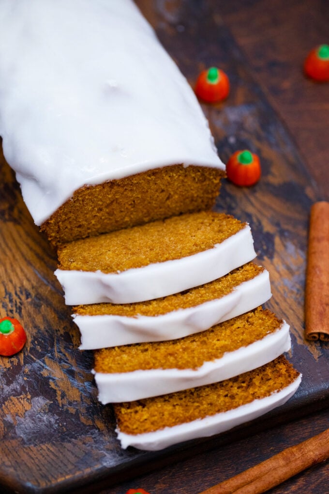 Sliced pumpkin bread with cream cheese frosting.