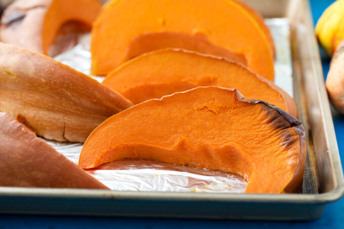 Roasting pumpkin slices.