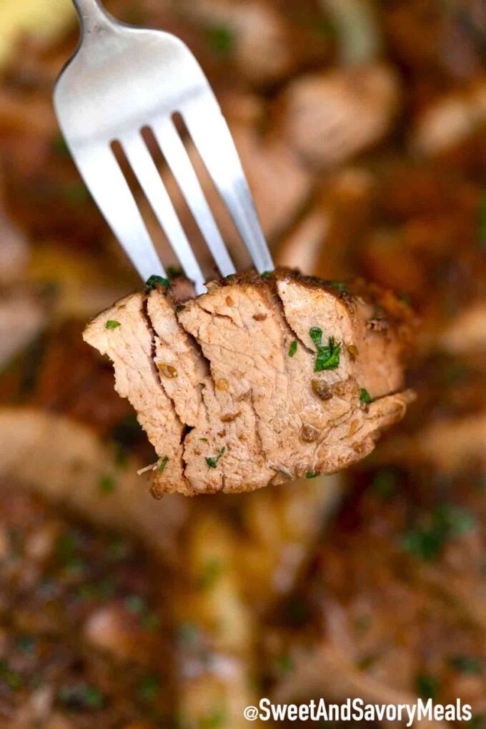 a fork with a slice of juicy pork tenderloin cooked in a slow cooker