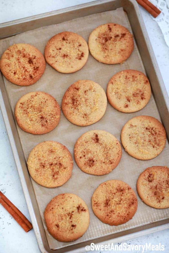 Fresh and soft brown sugar cookies on a baking sheet garnished with cinnamon