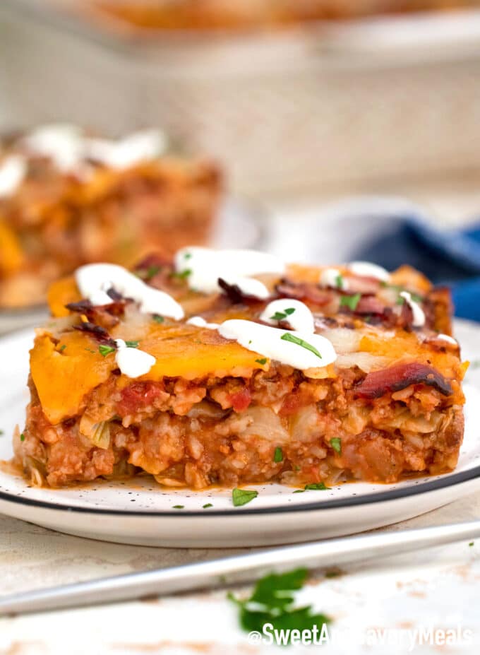 sliced stuffed cabbage casserole topped with white sauce