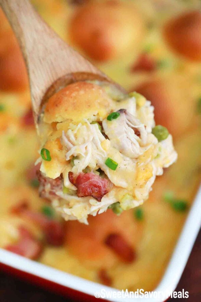 A spoonful chicken and dumplings with bacon