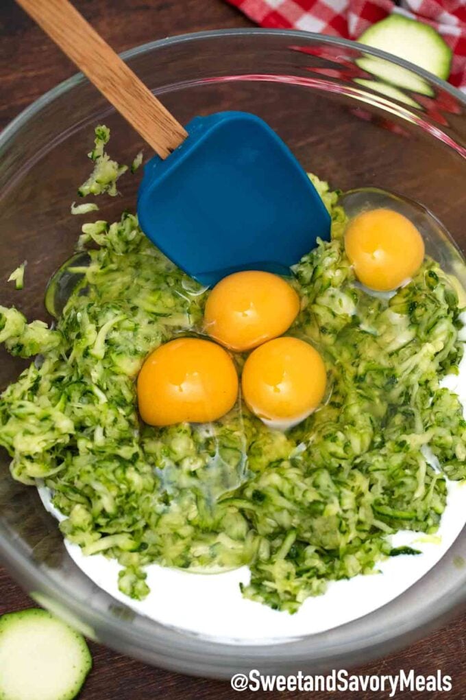 sliced zucchini with sour cream and eggs in a large glass bowl