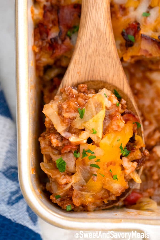 stuffed cabbage casserole with bacon with a wooden spoon inside. 