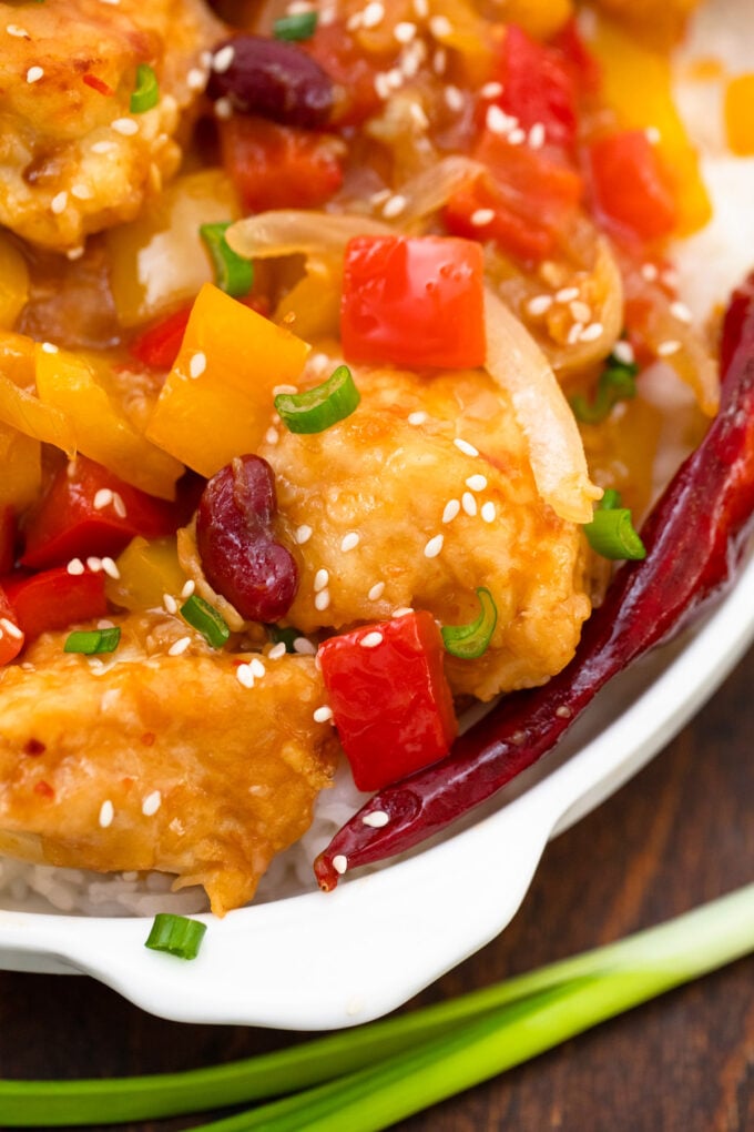 Crispy homemade Panda Express Firecracker Chicken with bell peppers and black beans.