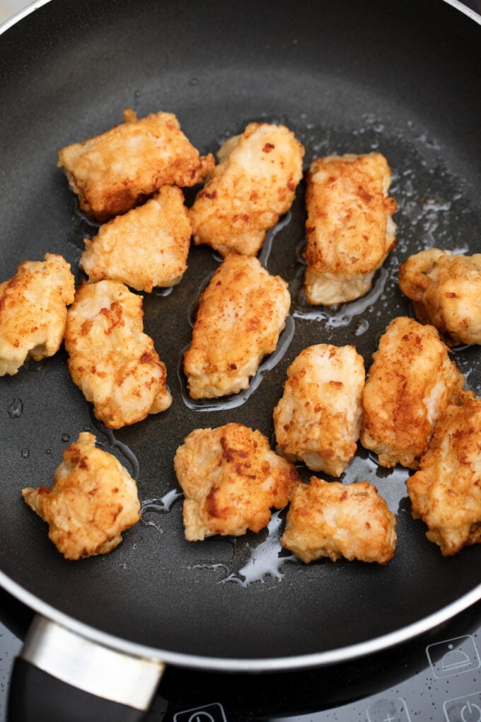 Frying breaded chicken peices.