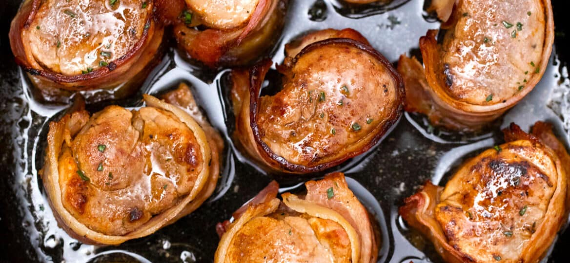 bacon wrapped pork medallions in a cast iron skillet