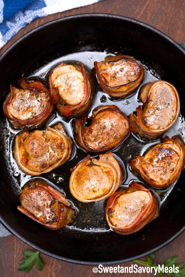 bacon wrapped pork medallions in a cast iron skillet