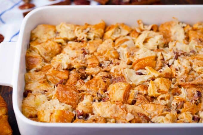 Croissant French toast casserole ingredients in a baking dish.