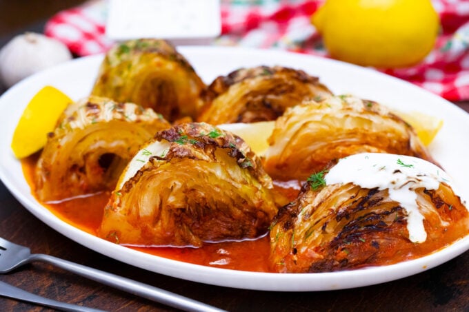 Caramelized cabbage wedges in tomato sauce.