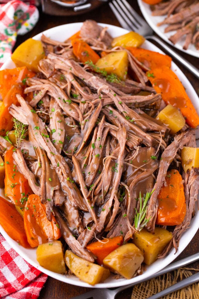 Overhead shot of shredded crockpot red wine pot roast and veggies.