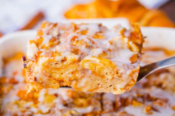A slice of croissant French toast casserole on a serving spatula.