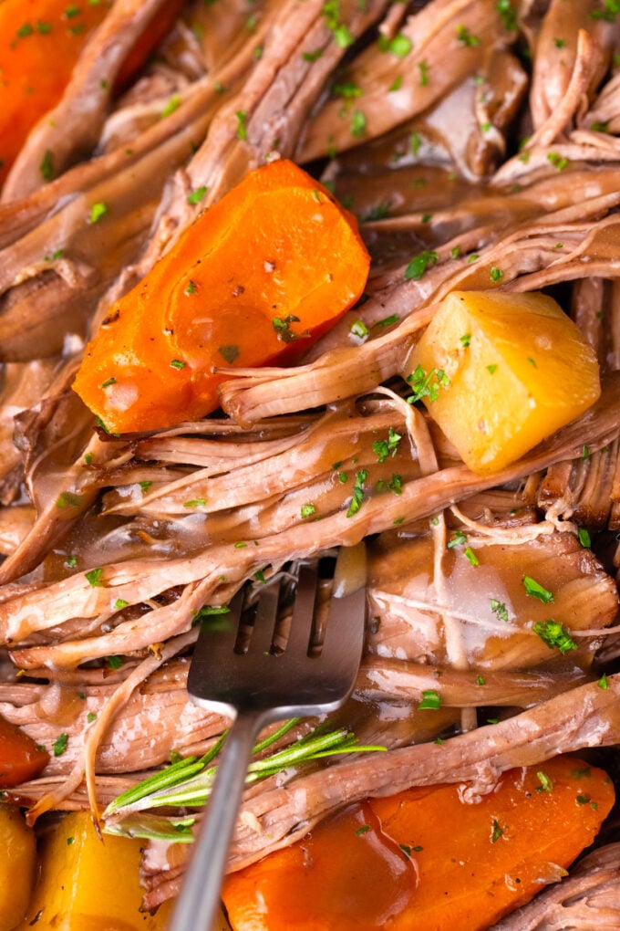 Slow cooker red wine pot roast with carrots and potatoes.