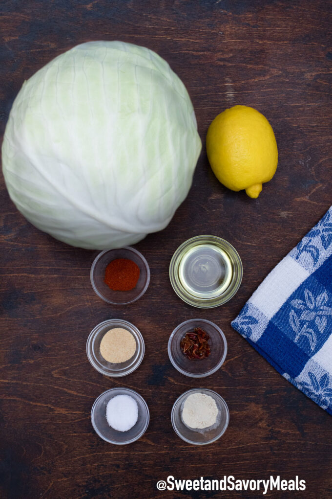 whole cabbage and seasoning in individual small bowls on a table