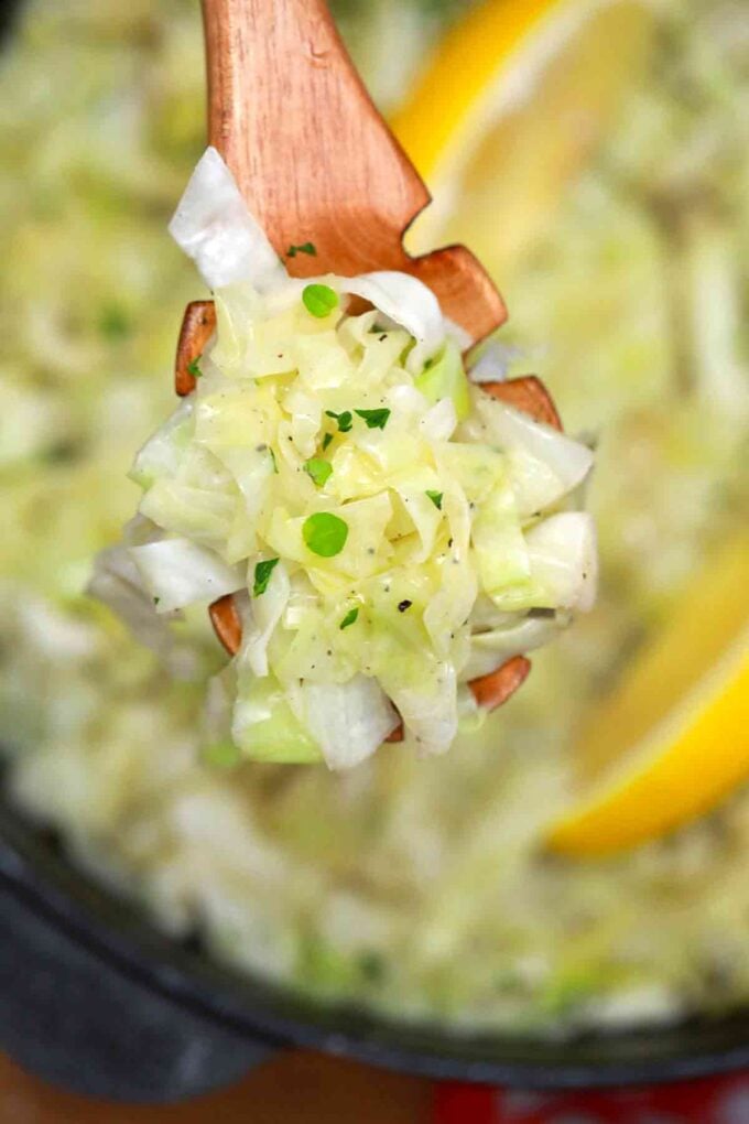 Sautéed cabbage with oregano on a wooden spoon