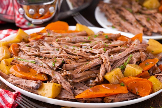 Homemade slow cooker red wine pot roast with carrots and potatoes.