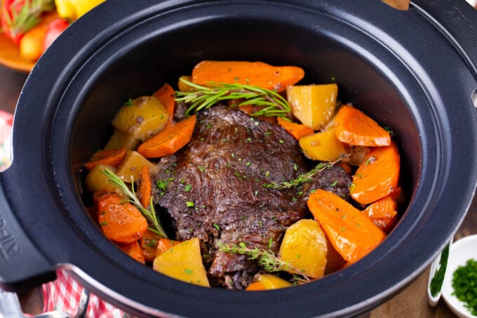 Slow cooker red wine pot roast with rosemary, potatoes and carrots.