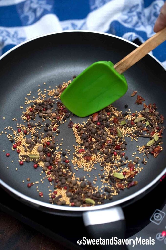 toasting homemade corned beef pickling spices in a skillet