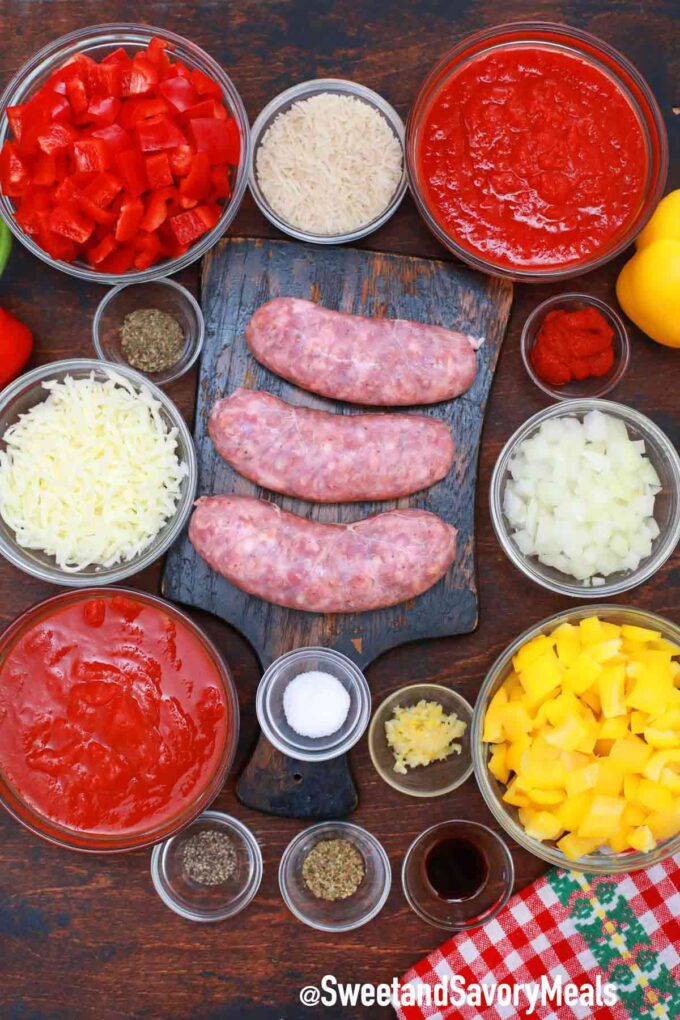 unstuffed peppers ingredients in bowls and ground sausage on a cutting board