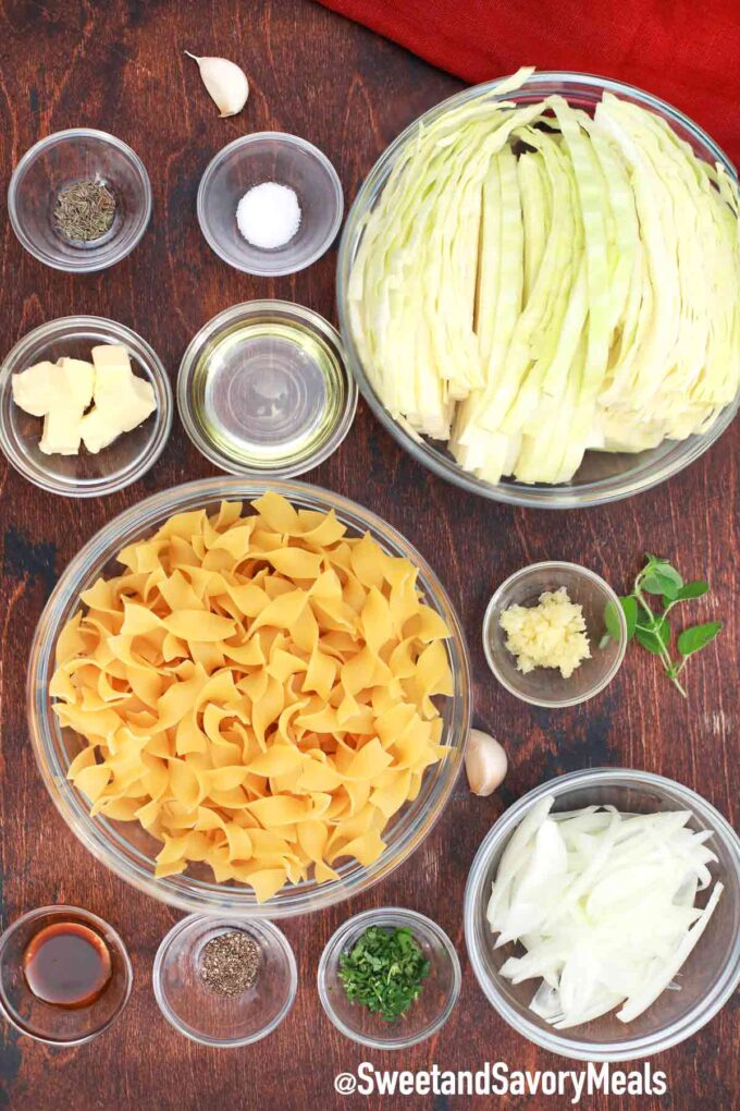 Fried cabbage and noodles ingredients on a wooden table