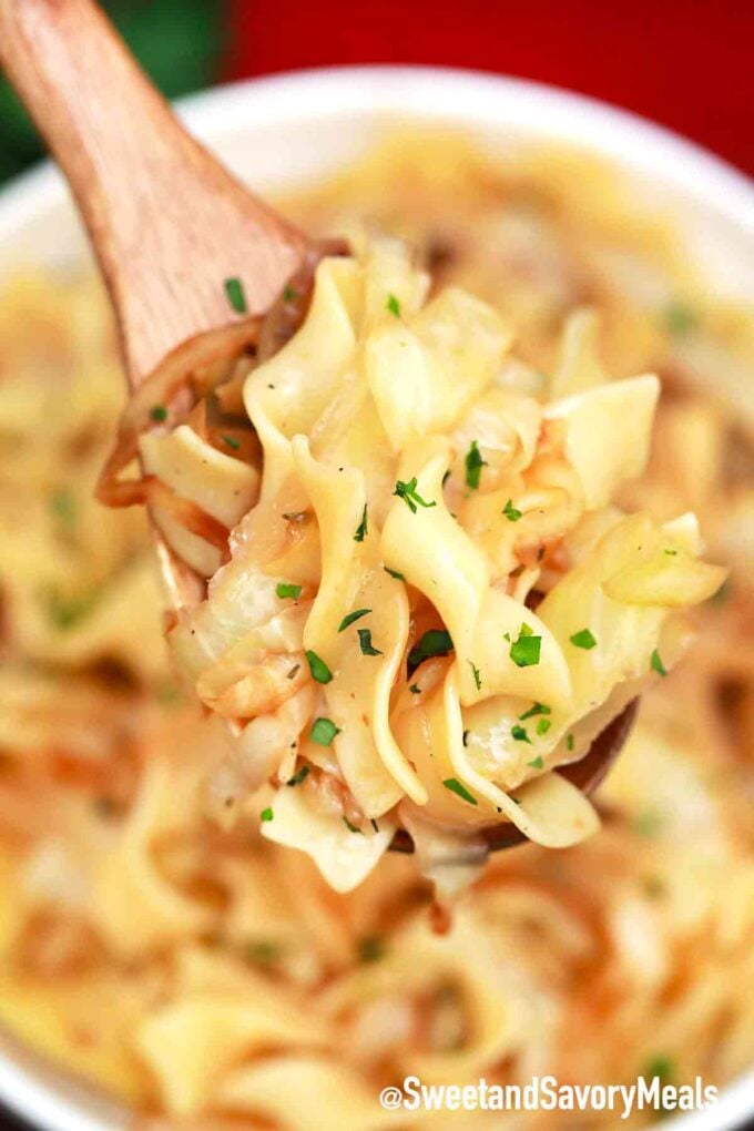 a spaghetti spoon of fried cabbage and noodles