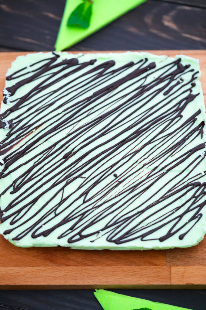 Green Irish mint brownies drizzled with melted chocolate.