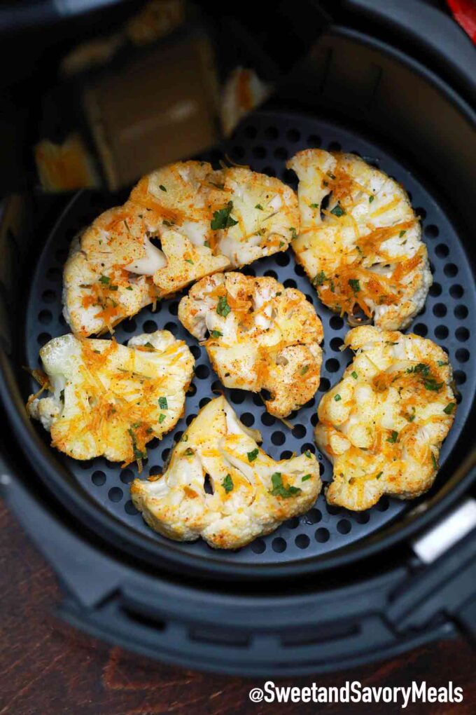 cauliflower seasoned and roasted in the air fryer basket