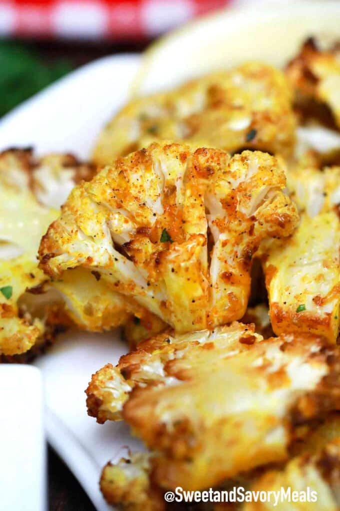 crispy air fryer cauliflower seasoned with paprika on a plate